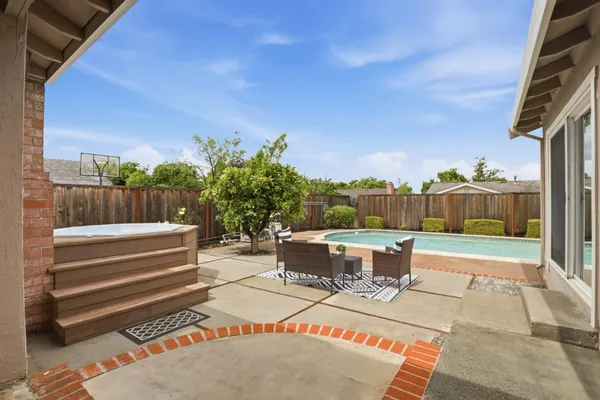 a view of a patio with a table and chairs