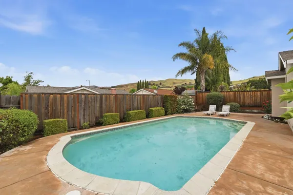 a swimming pool with outdoor seating and yard