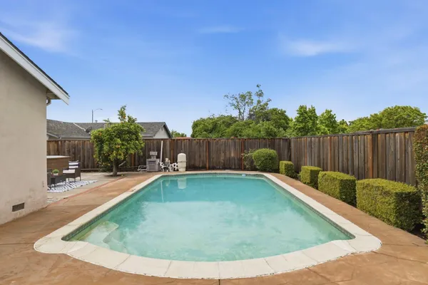 a view of a backyard with swimming pool