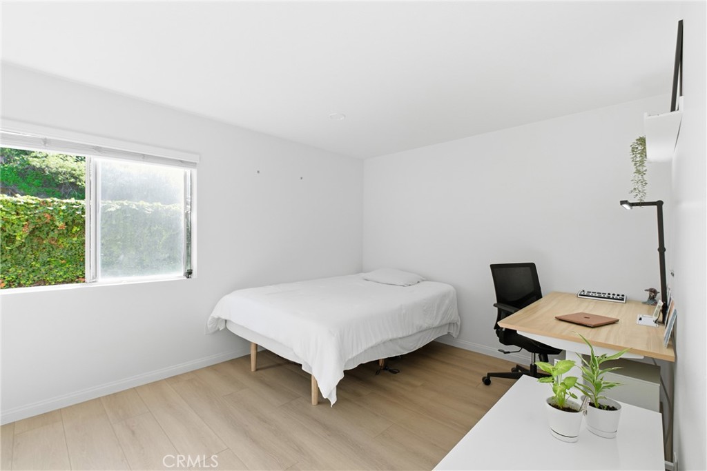 20921 Serrano Creek Road, Unit 55 Lake Forest, CA 92630 - Photo 12 of 26 a bedroom with a bed and a table in it