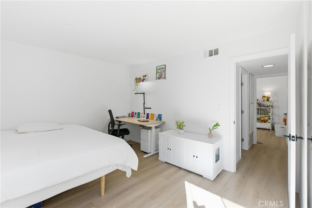 20921 Serrano Creek Road, Unit 55 Lake Forest, CA 92630 - Photo 13 of 26 a bedroom with a bed and a chandelier