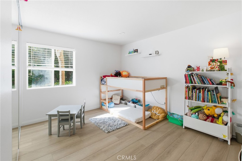 20921 Serrano Creek Road, Unit 55 Lake Forest, CA 92630 - Photo 17 of 26 a bedroom with furniture and a book shelf