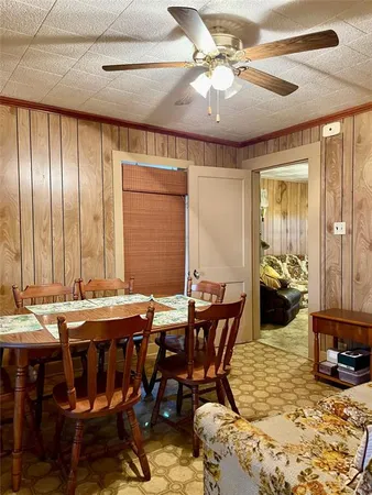 a view of a dining room and hall with furniture