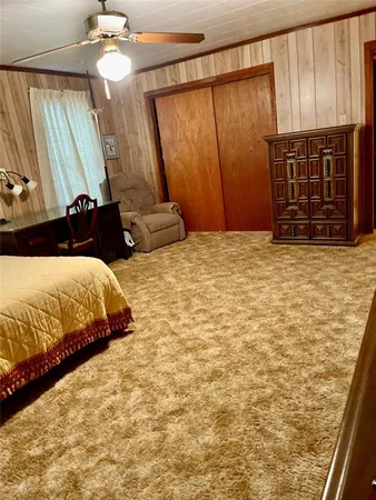 a bedroom with a bed dresser and a window