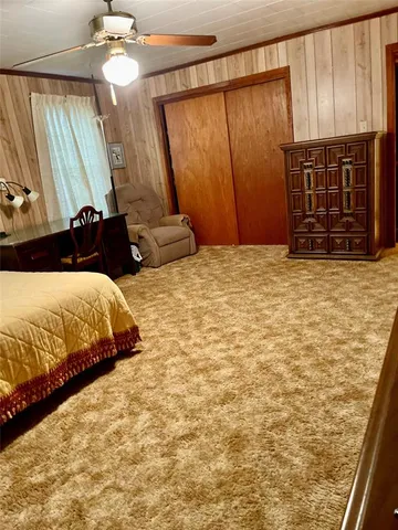 a bedroom with a bed dresser and a window