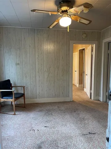 a view of a livingroom with furniture and chandelier fan