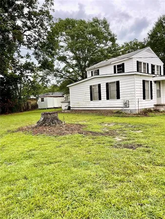 a white house with a large pool in front of it