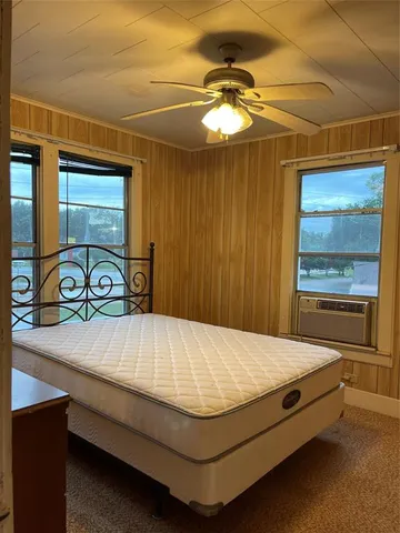 a bed sitting in a room next to a window