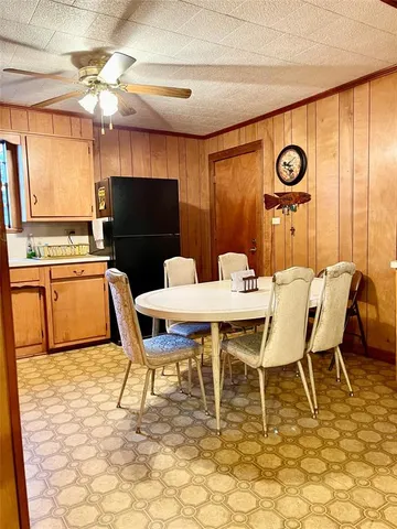 a dining room with furniture and a large window