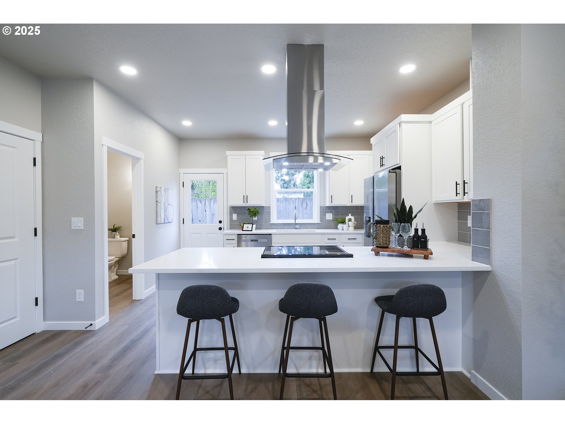 4537 Southeast 97th Avenue Portland, OR 97266 - Photo 8 of 16 a kitchen with refrigerator and chairs