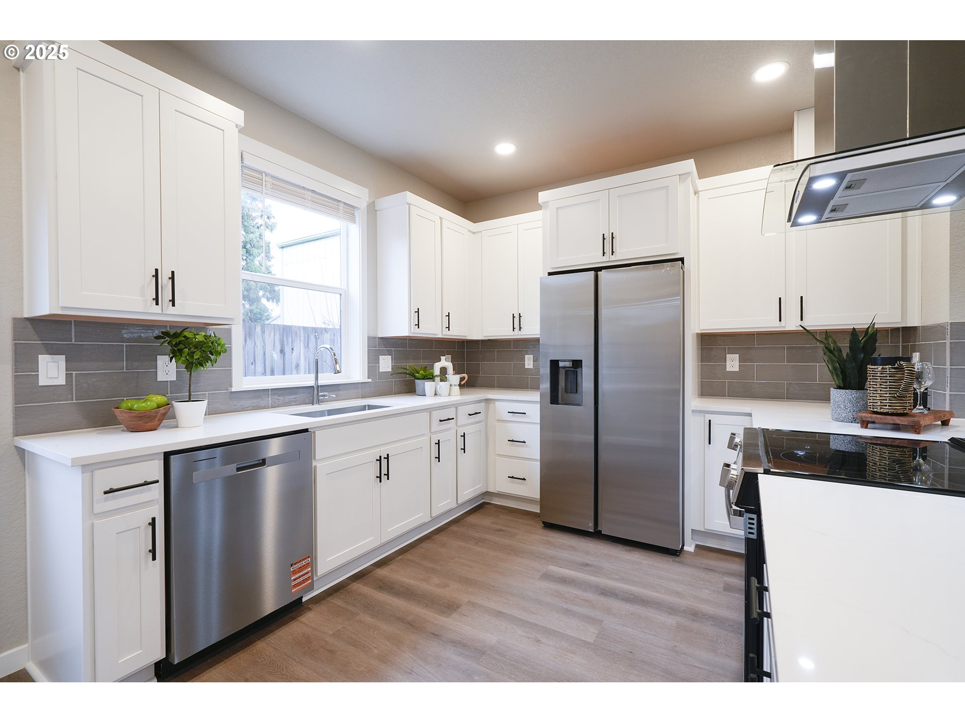 4537 Southeast 97th Avenue Portland, OR 97266 - Photo 9 of 16 a kitchen with a refrigerator a sink and cabinets