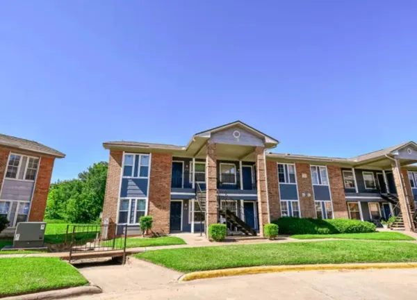 a front view of a building with a yard
