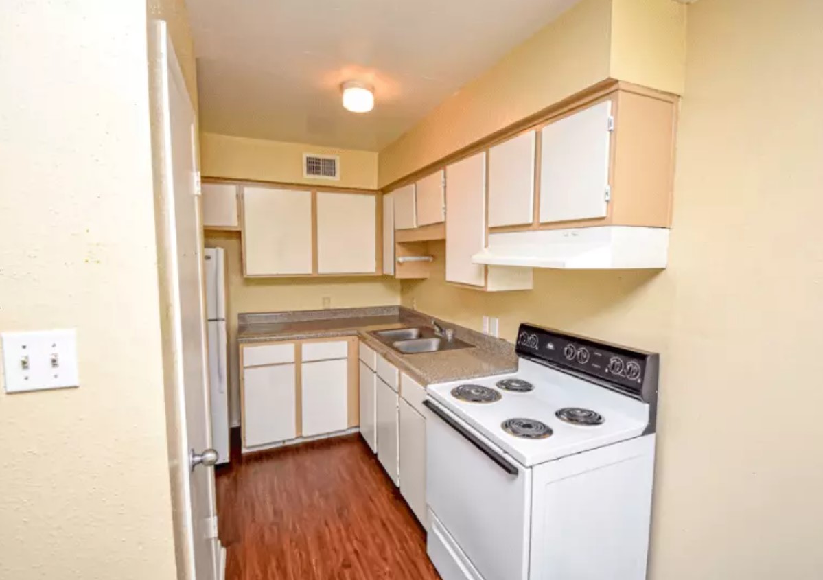 1400 Eagle Lake Road Sealy, TX 77474 - Photo 7 of 8 a kitchen with a stove a sink and a refrigerator