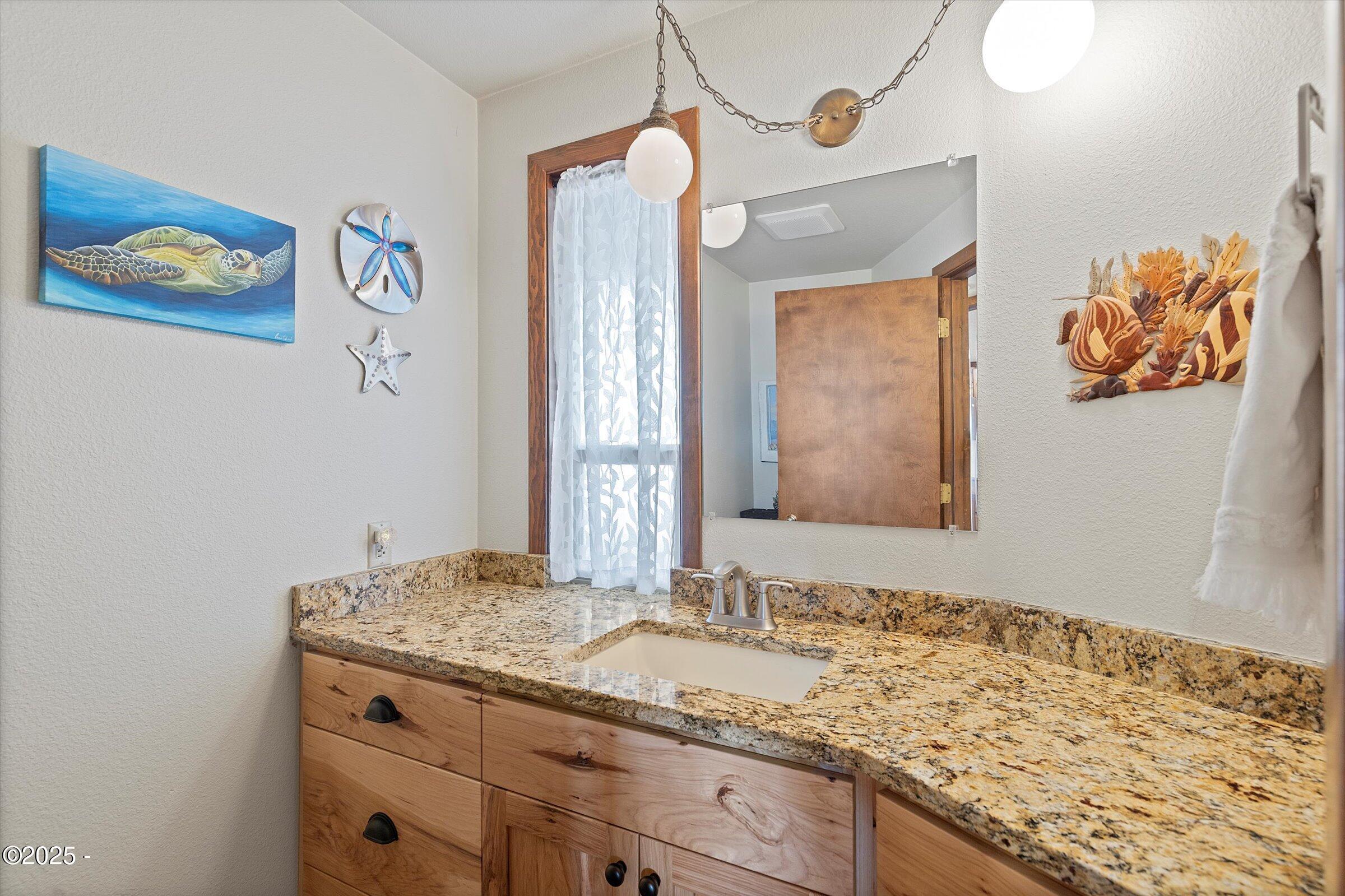 21560 Gooseneck Road Sheridan, OR 97378 - Photo 26 of 63 a bathroom with a granite countertop sink and a mirror