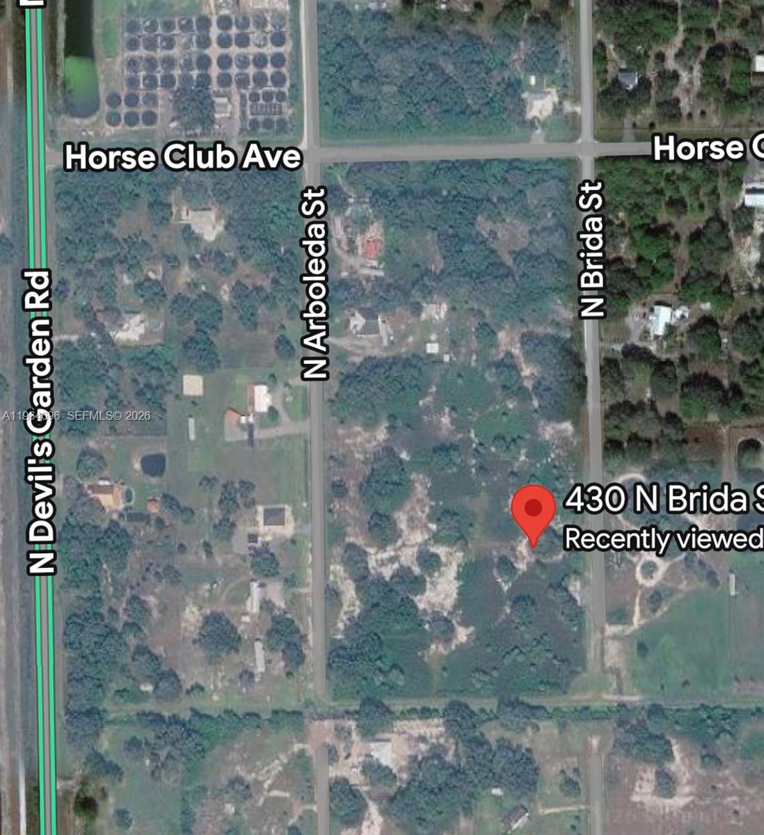 430 North Brida Street Clewiston, FL 33440 - Photo 4 of 4 a view of a glass door with a glass door