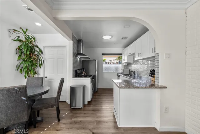 a large kitchen with a table and chairs