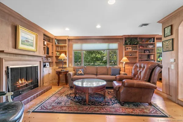 a living room with furniture a rug and a fireplace