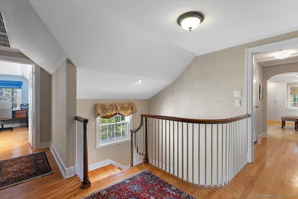 a view of a hallway with windows and stairs