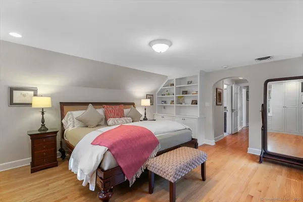 a bedroom with bed and wooden floor