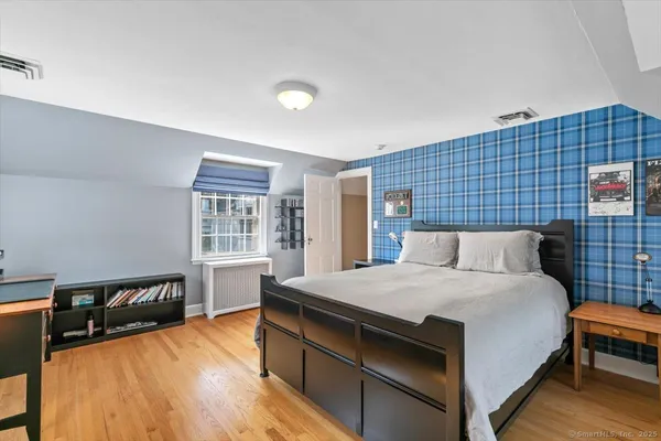 a bedroom with a bed and a night stand