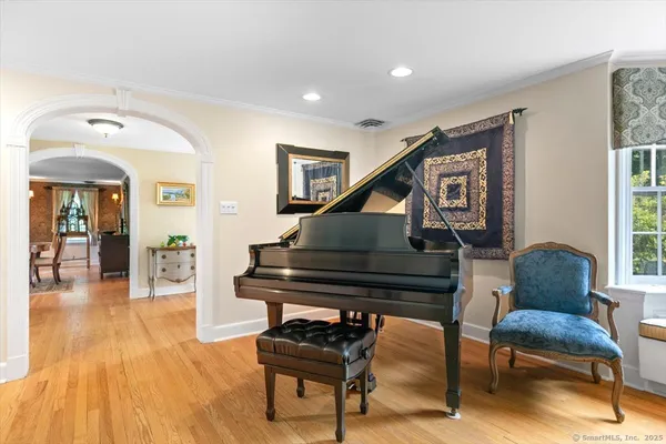 a living room with furniture and a piano