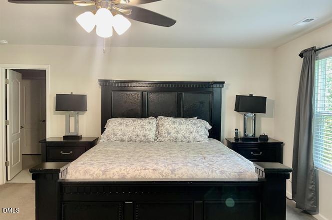 1807 Wrenn Road Durham, NC 27703 - Photo 38 of 43 a bedroom with a bed and a lamp on table