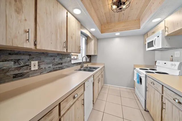 a kitchen with a sink cabinets and appliances