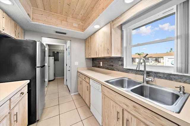 a kitchen with a sink cabinets and a refrigerator