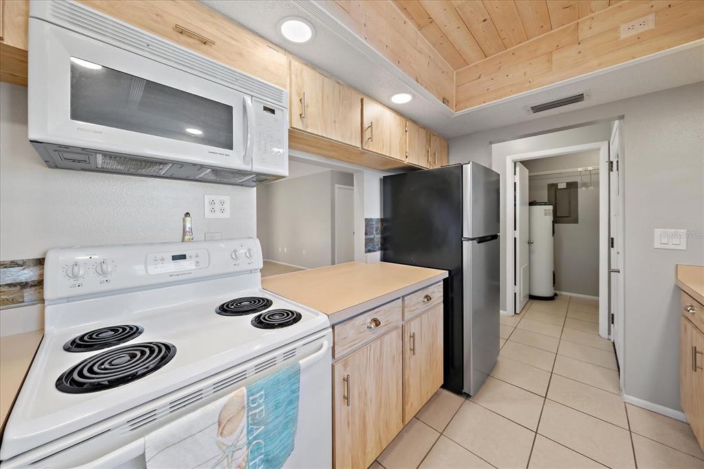 1946 Settlement Road, Unit 24 Venice, FL 34285 - Photo 21 of 51 a kitchen with a refrigerator and a stove top oven