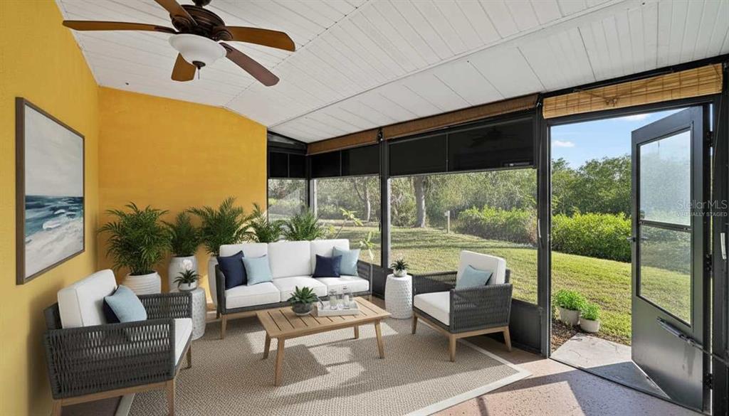 1946 Settlement Road, Unit 24 Venice, FL 34285 - Photo 24 of 51 a living room with patio furniture and a floor to ceiling window