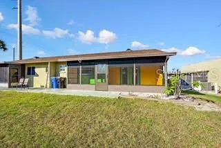 a front view of a house with a garden and yard