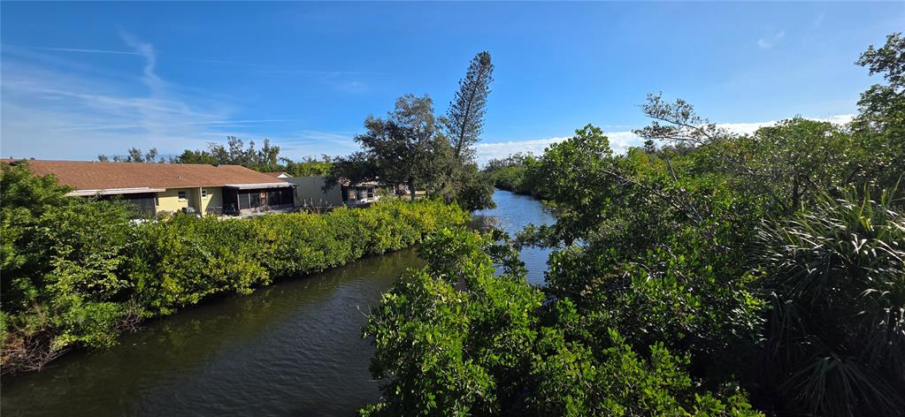 1946 Settlement Road, Unit 24 Venice, FL 34285 - Photo 34 of 51 a view of a house with a yard and a pond