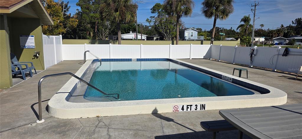 1946 Settlement Road, Unit 24 Venice, FL 34285 - Photo 38 of 51 a view of swimming pool with outdoor seating and plants