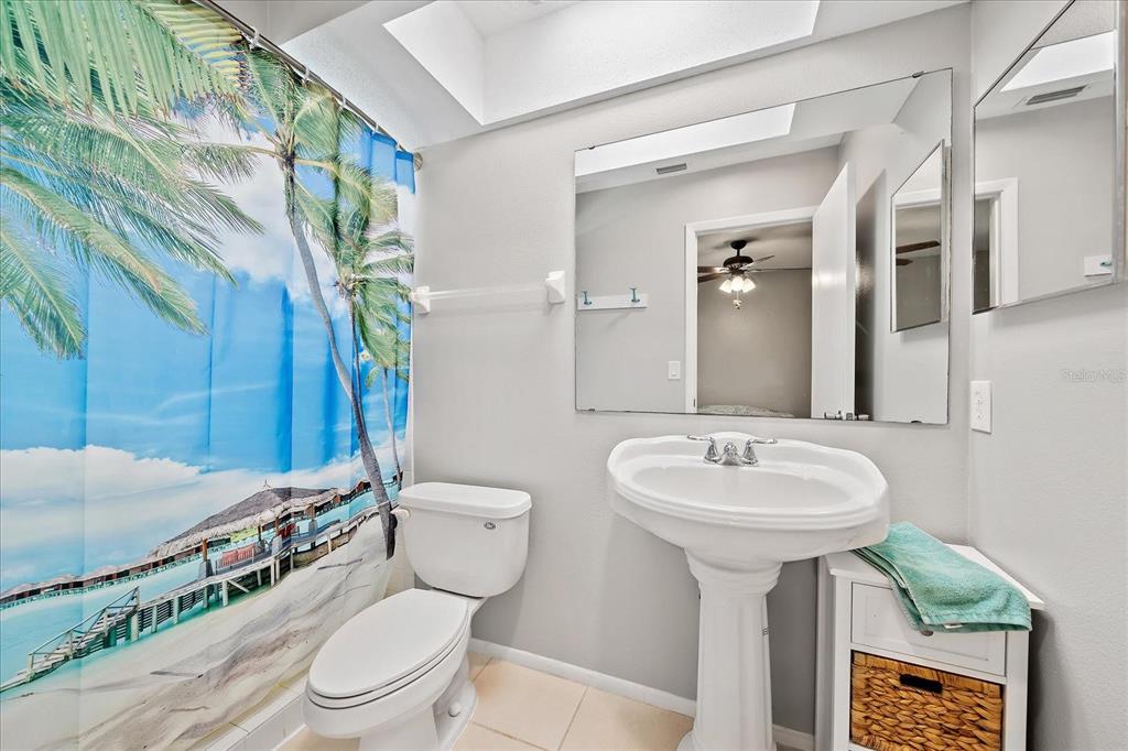 1946 Settlement Road, Unit 24 Venice, FL 34285 - Photo 4 of 36 a bathroom with a toilet sink and mirror