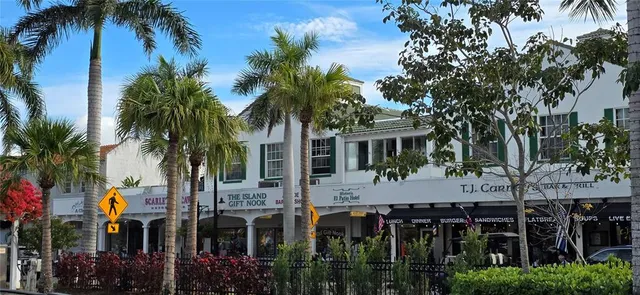 a front view of house with palm trees