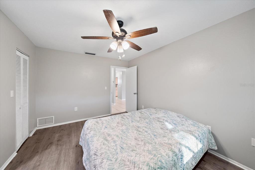 1946 Settlement Road, Unit 24 Venice, FL 34285 - Photo 5 of 36 a bedroom with a bed and a ceiling fan