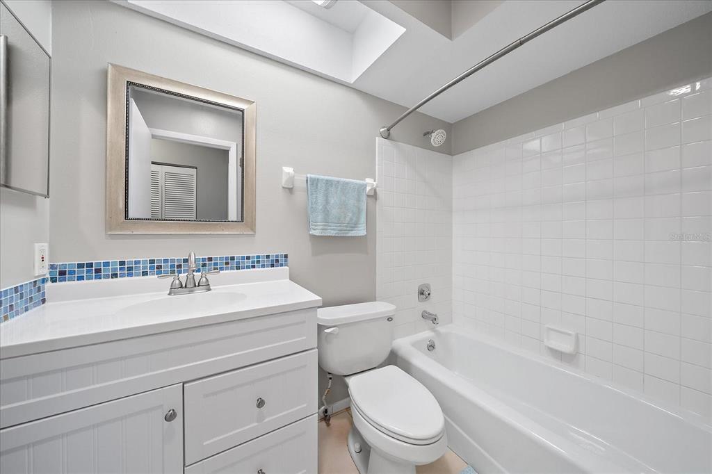 1946 Settlement Road, Unit 24 Venice, FL 34285 - Photo 6 of 36 a bathroom with a toilet a sink a mirror a bathtub and vanity