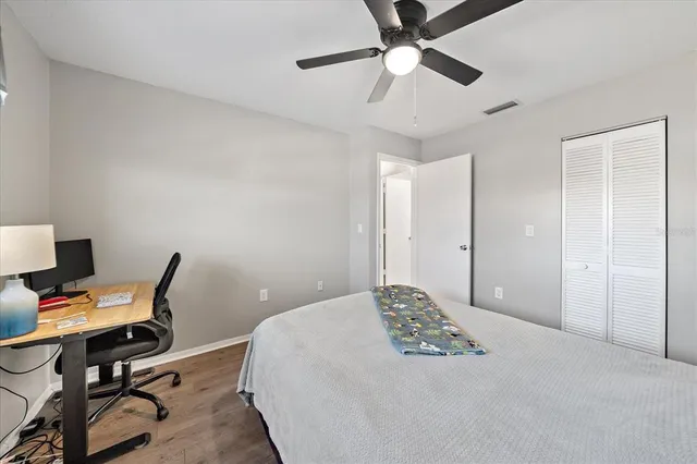 a bedroom with a bed and a desk