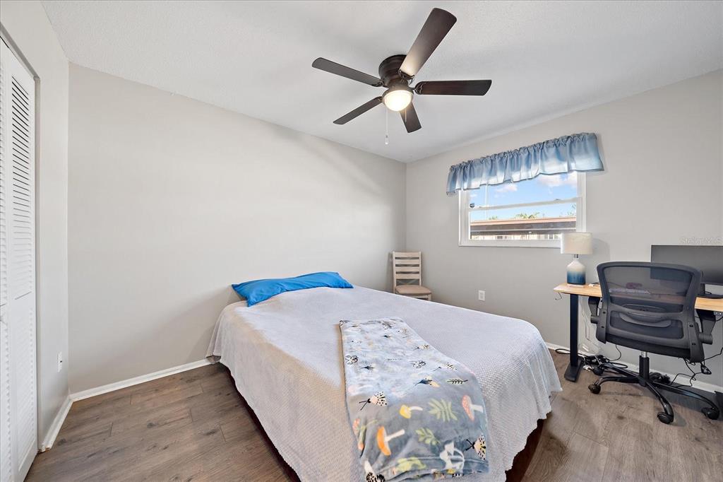 1946 Settlement Road, Unit 24 Venice, FL 34285 - Photo 7 of 36 a bedroom with a bed a desk and chair