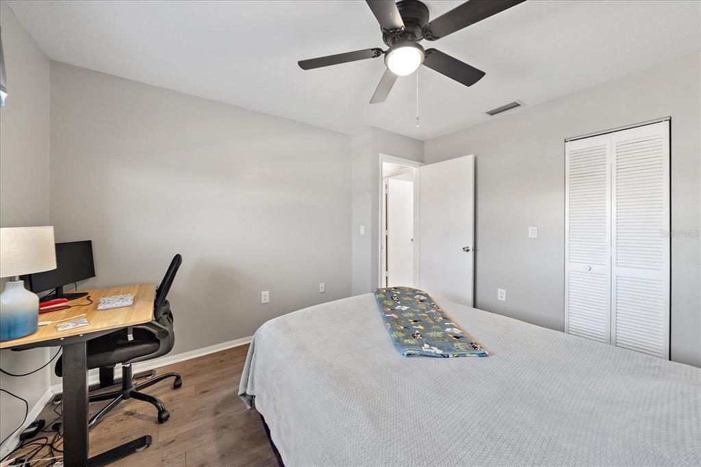 1946 Settlement Road, Unit 24 Venice, FL 34285 - Photo 8 of 36 a bedroom with a bed and a desk