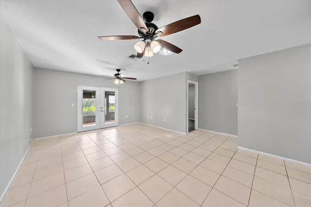 a view of an empty room and a ceiling fan
