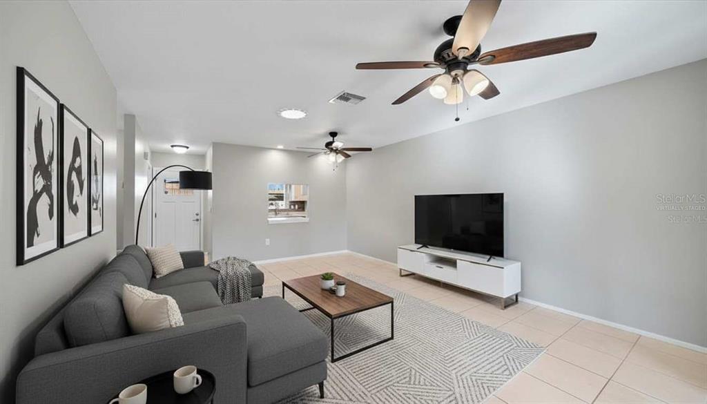 1946 Settlement Road, Unit 24 Venice, FL 34285 - Photo 10 of 51 a living room with furniture and a flat screen tv