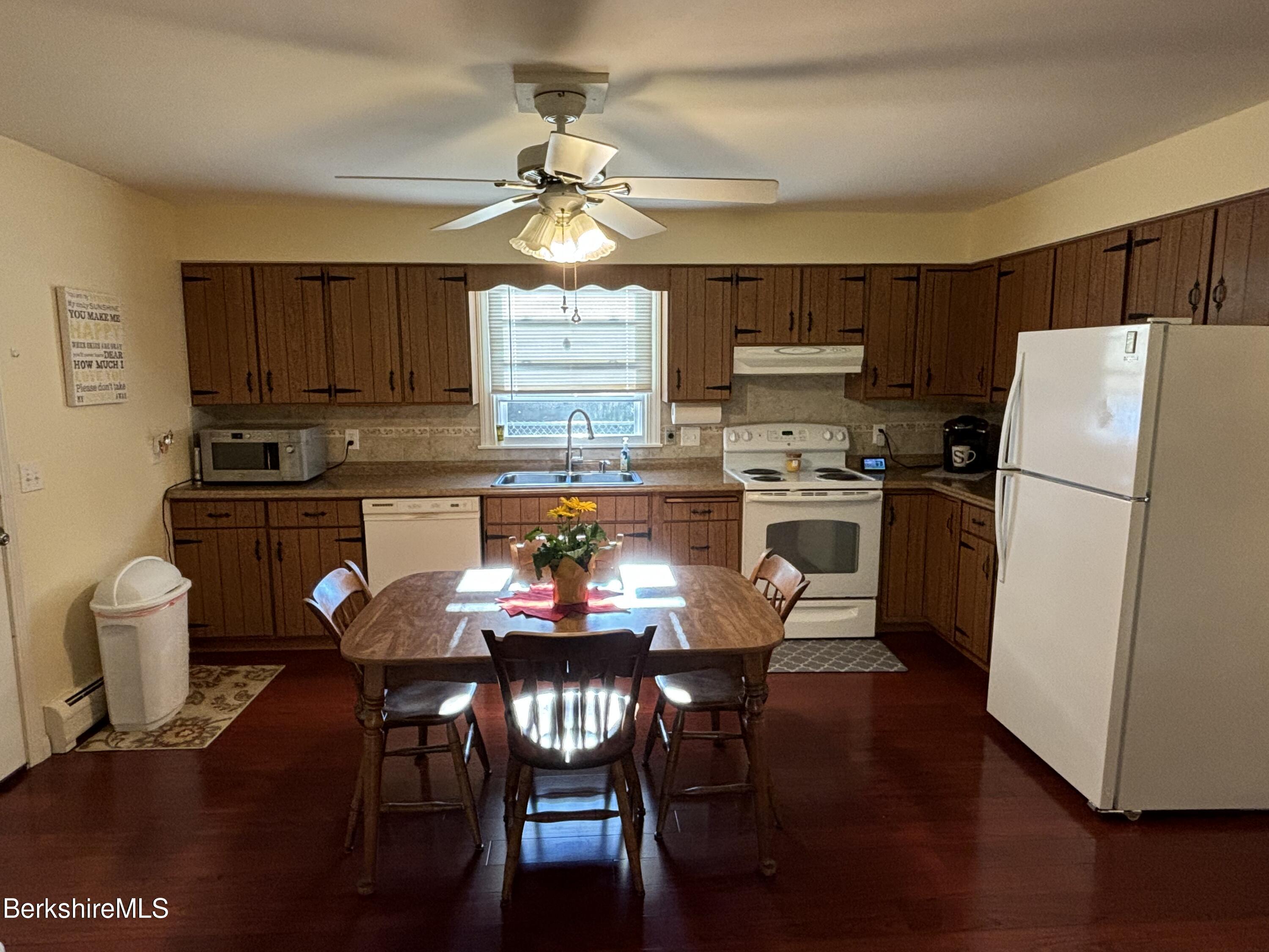 1435 River Road Clarksburg, MA 01247 - Photo 18 of 55 a kitchen with stainless steel appliances a dining table chairs refrigerator and sink