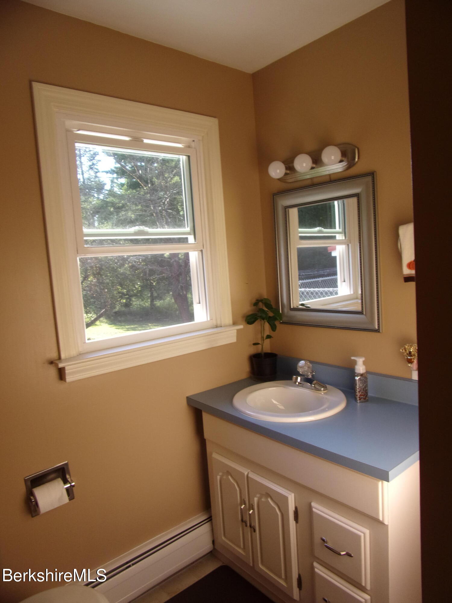 1435 River Road Clarksburg, MA 01247 - Photo 23 of 55 a bathroom with a sink a mirror and a window
