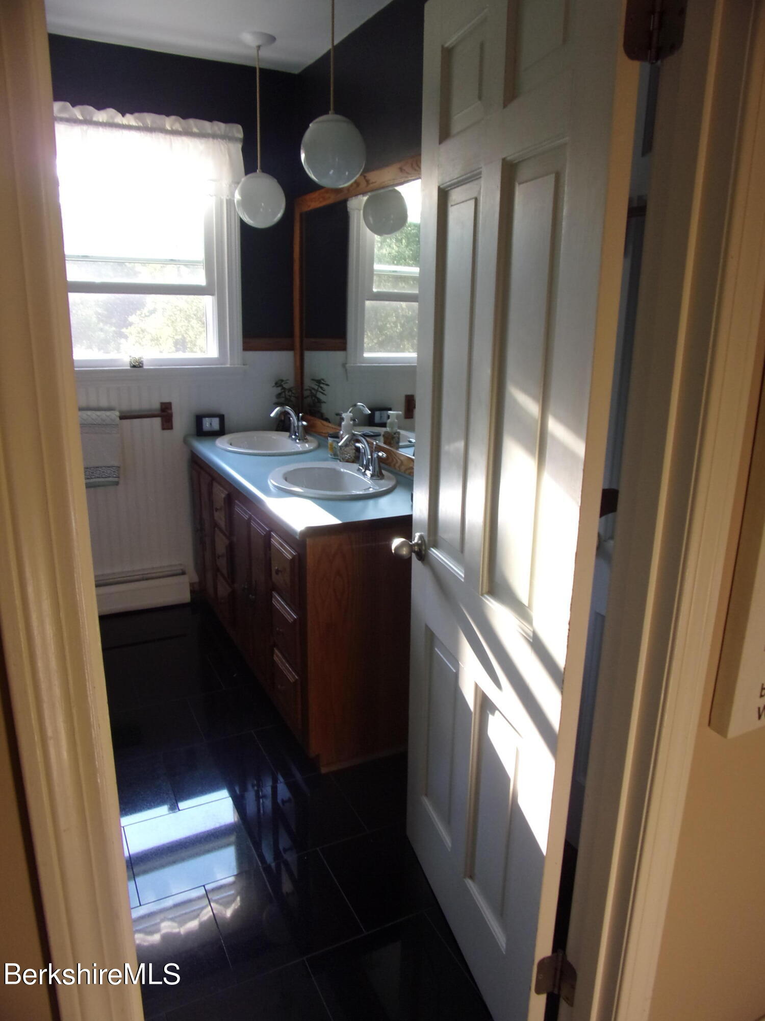 1435 River Road Clarksburg, MA 01247 - Photo 32 of 55 a bathroom with a sink a toilet a mirror and window