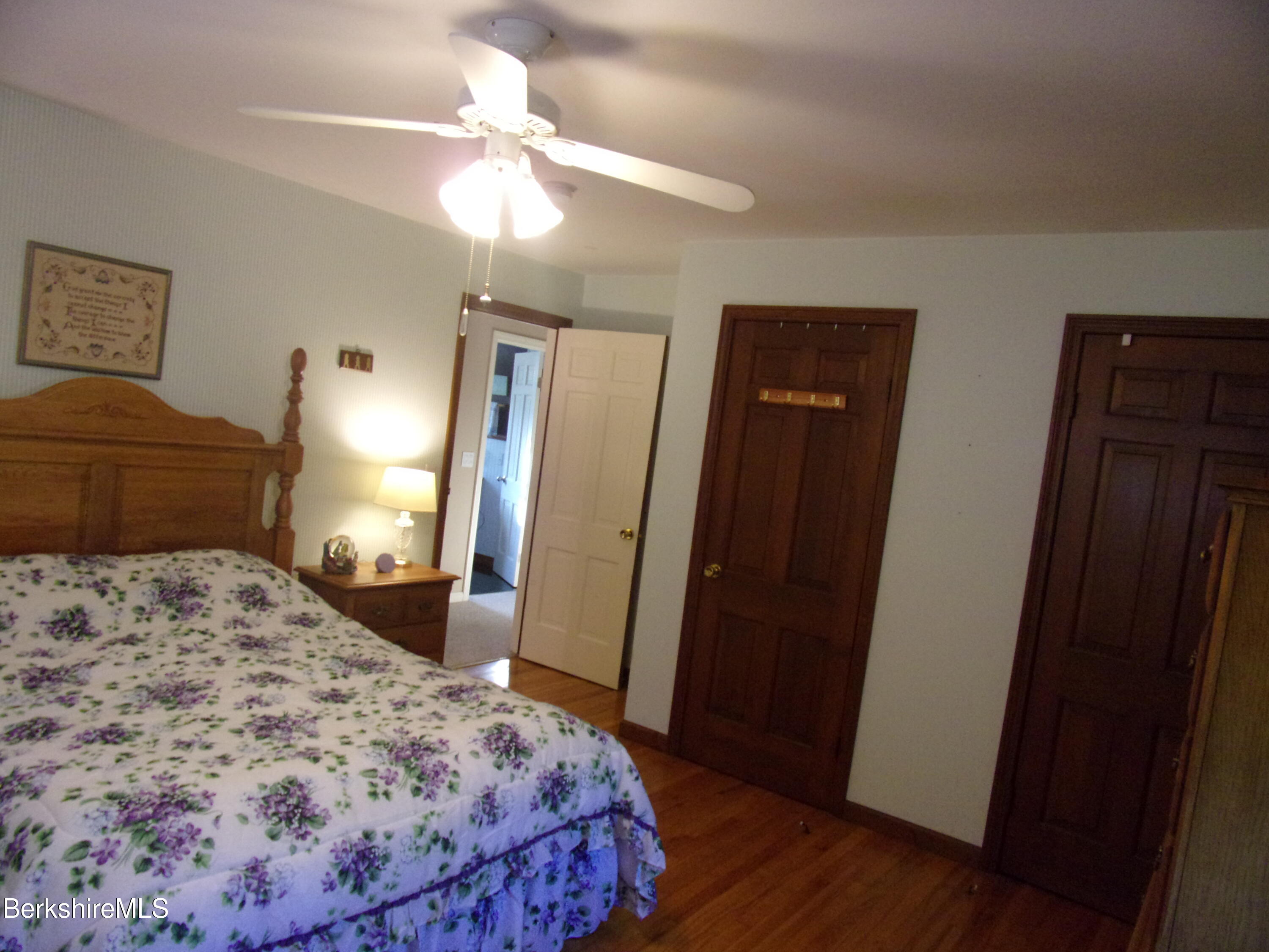 1435 River Road Clarksburg, MA 01247 - Photo 36 of 55 a bedroom with a bed and a mirror on dresser