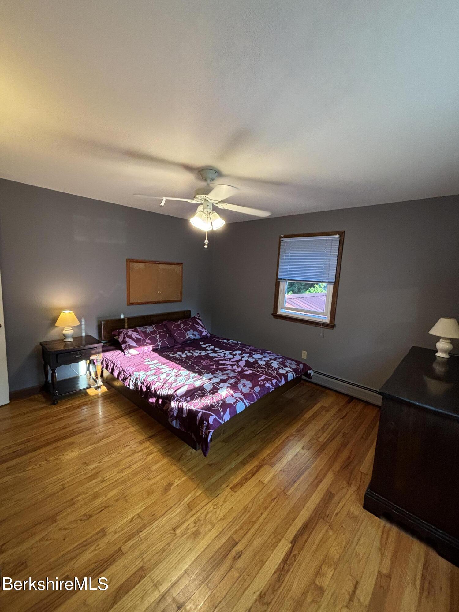 1435 River Road Clarksburg, MA 01247 - Photo 37 of 55 a bedroom with a bed and a lamp on dresser