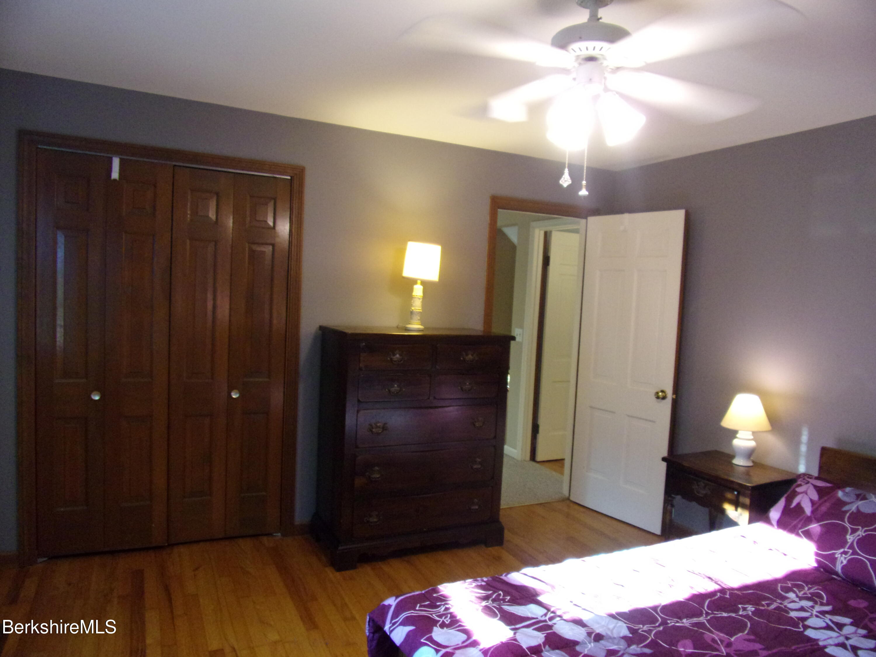 1435 River Road Clarksburg, MA 01247 - Photo 39 of 55 a bedroom with a bed and a chandelier