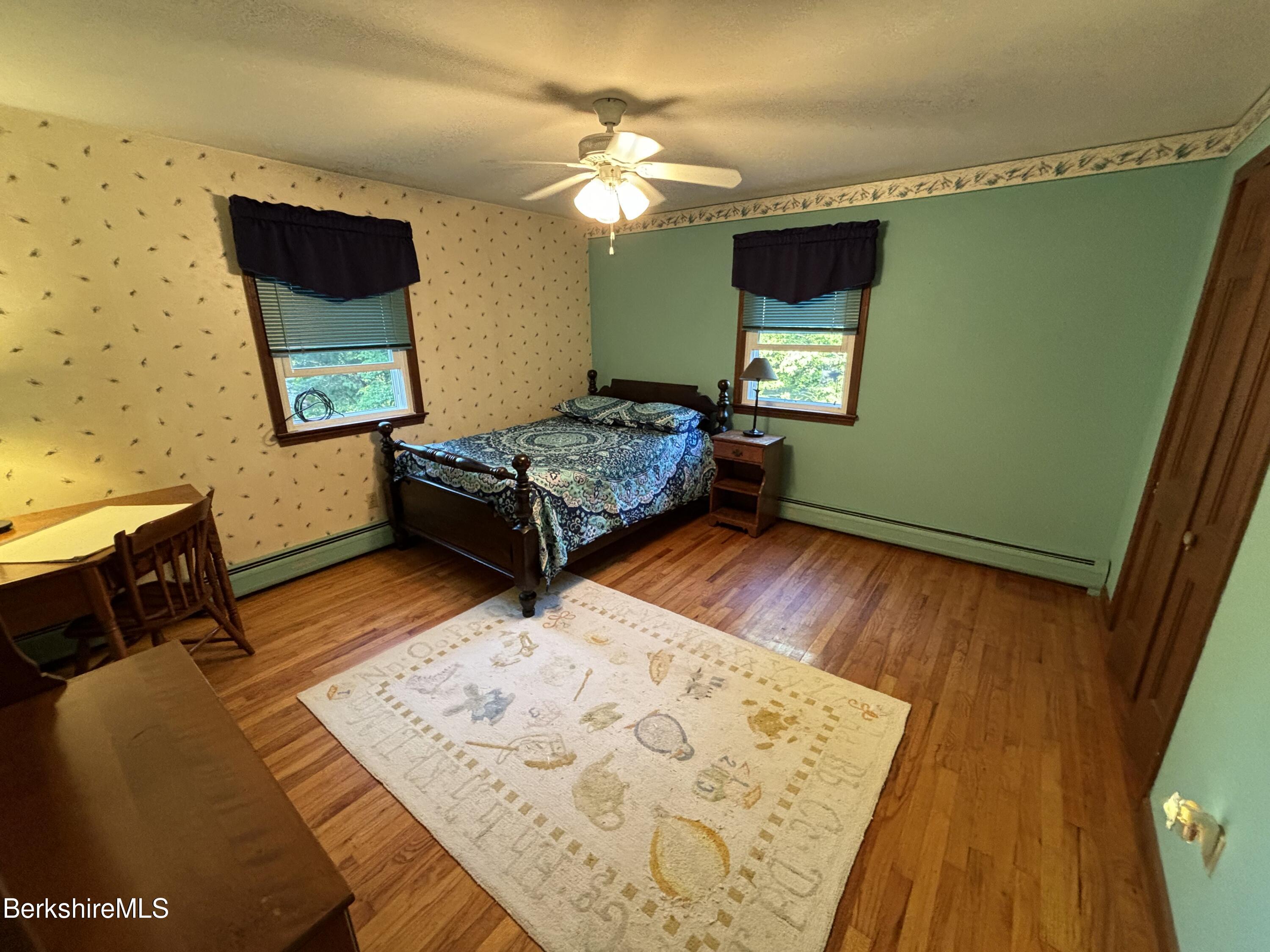 1435 River Road Clarksburg, MA 01247 - Photo 41 of 55 a living room with a bed furniture and a wooden floor
