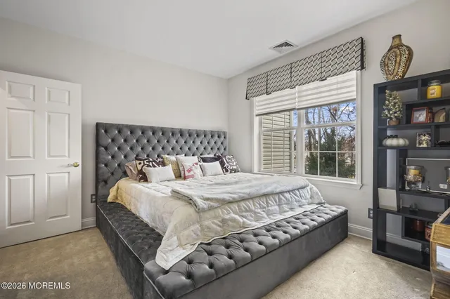 a bedroom with bed and window